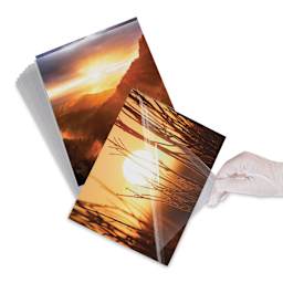 Lineco Digital Print Sleeve Pack - 11" x 14", , Clear, Pkg of 25, hand peeling off the sleeve