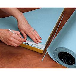 Lineco Backing Paper being applied to the back of a frame