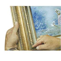 Amaco Nail Hole and Corner Filler - Closeup of hands filling small hole in frame