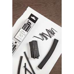 Coates Premium Artist's Willow Charcoal, assorted sizes on desk with swatches