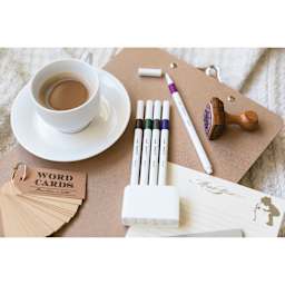 Uni Emott Fineliners - Set of 5, Vintage Colors (sitting on a table with one pen uncapped)