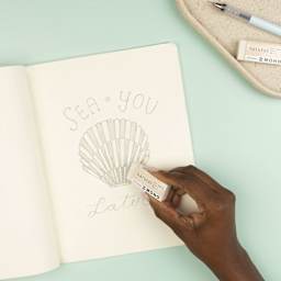 Tombow Mono Natural Eraser, in hand erasing drawing on paper