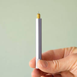 Tom's Studio Lumos Mini Refillable Pen - Lilac, pen in hand