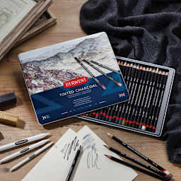 24 pc Derwent Tinted Charcoal Pencils Set open, and pencils being used on white paper.