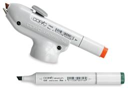 Copic Air Grip with Orange Copic marker loaded, and Green Copic marker nearby (Markers not Included)