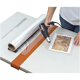 Mountex Shrink Wrapper Kit - Artist using heat gun from Kit