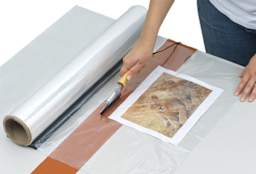 Mountex Shrink Wrapper Kit - Artist using film sealer from Kit
