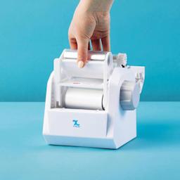 Xyron Create-A-Sticker Mini Permanent Refill Cartridge, refill being loaded into sticker maker