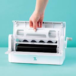 Xyron Creative Station Laminated Magnet Refill Cartridge - 9" x 10' seated within laminator