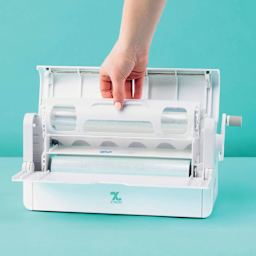 Xyron Creative Station Two-Sided Laminate Refill Cartridge - 9" x 40' seated inside of laminator