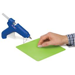 Surebonder Glue Gun Silicone Pad - Hand peeling glue off 8" square pad with glue gun nearby