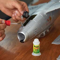 Krazy Glue All Purpose Super Glue - Hands assembling wheel on model Plane with Super Glue