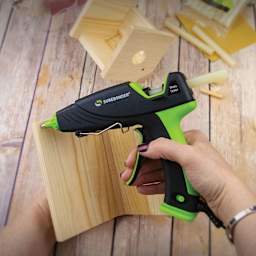 Surebonder Ultra Series Dual Temp Glue Gun - 60 Watt, in hand applying glue onto wood piece