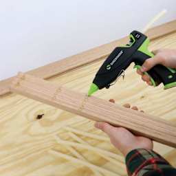 Surebonder Ultra Series Dual Temp Glue Gun - 100 Watt, in hand applying glue onto wood
