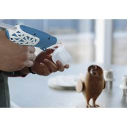 Studio Designs Cordless Glue Gun - Blue and White w/ Web Grip - in use, close-up