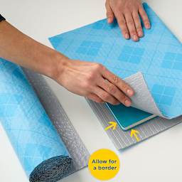 Scotch Flex & Seal Shipping Roll - Person measuring and cutting roll