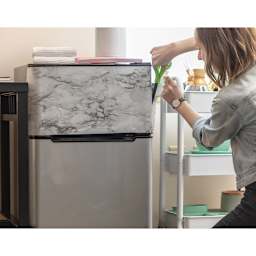 Duck EasyLiner Adhesive Laminate - Teacher adding Gray Marble laminate to side of desk