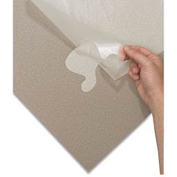 Artool Art Mask Frisket Film Roll - Closeup of cut corner of Roll on top of matboard