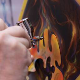 Artool True Fire Freehand Template - Closeup of artist using True Fire II template with airbrush