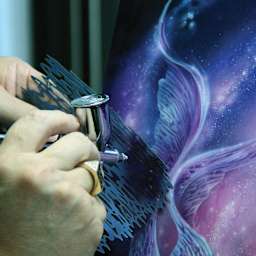Iwata Artool Freehand Template - Artist using mini template to add texture to fish fins painting