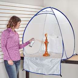 HomeRight Spray Shelters - Photo of woman with spray can spraying a lamp base in small shelter