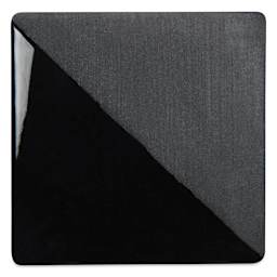 Speedball Ceramic Underglaze - Black, Opaque, fired on white clay bisque tiles, half covered in Speedball Clear Glaze, fired to cone 05