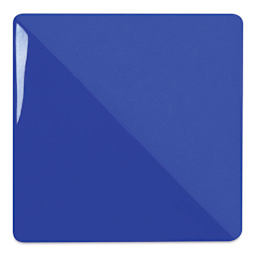 Speedball Ceramic Underglaze - Royal Blue, Opaque, fired on white clay bisque tiles, half covered in Speedball Clear Glaze, fired to cone 05