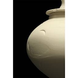 Amaco No. 25 White Art Clay - Left side of lidded pot against black background.