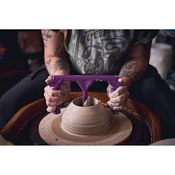 Speedball Boss Base Clay Ball Opener being used on clay