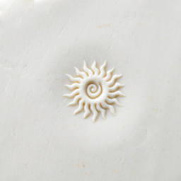 MKM Pottery Tools Curve Top Stamp - Spiral Sun - stamped into clay