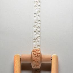 MKM Pottery Tools Small Handle Roller - Embossed Flowers applied to clay