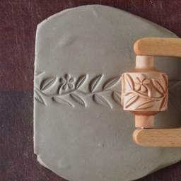 MKM Pottery Tools Medium Handle Roller - Flowers & Leaves applied to clay