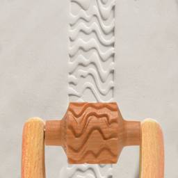 MKM Pottery Tools Medium Handle Roller - Curvy Zebra applied to clay