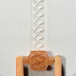 MKM Pottery Tools Medium Handle Roller - Double Helix applied to clay