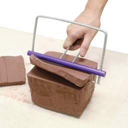 Amaco Adjustable Clay Slicer - Artist using slicer to cut clay slab approximately one inch thick