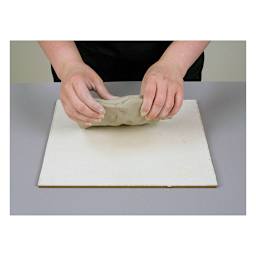 Amaco Canvas-Covered Board - Artist's hands about to work clay on board