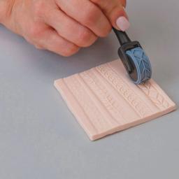 Sculpey Tools Texture Wheel Set - rolling texture wheel on clay