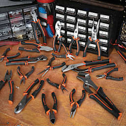GreatNeck Pliers - assortment of all pliers on workbench