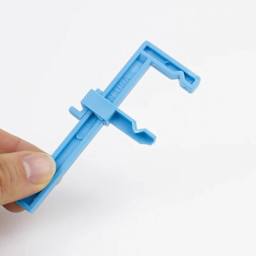 Excel Blades Small Adjustable Plastic Clamp in hand