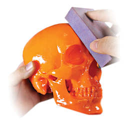 Smooth-On XTC-3D High-Performance 3D Print Coating - Plastic skull being sanded by artist