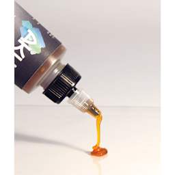 Akua Tack Thickener, being poured from the nozzle