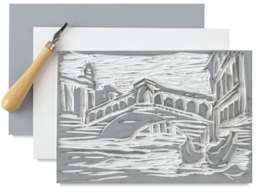 Blick Readycut Printing Block - Art of Bridge carved into block with tool and 2 more blocks beneath