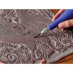 Speedball Red Baron Unmounted Linoleum Sheets being carved by gouge blade