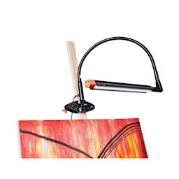 Daylight Techne 2 Artist & Drafting Lamp - Black and Orange, attached to an easel