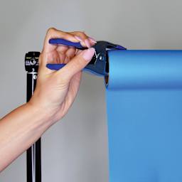 Savage Spring Clamps - Hand attaching clamp to Backdrop Roll of paper