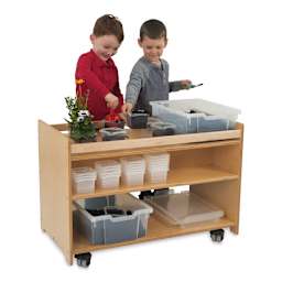 Whitney Brothers Mobile Garden Center - Children planting seeds in tubs on cart