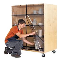 Diversified Spaces Sculpture Ware Cart - Artist placing ceramic vase on shelf to dry