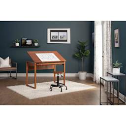 Studio Designs Retro Stool, in front of a drafting table station inside a room