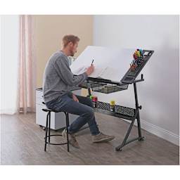 Studio Designs Fusion Center- Man sitting drawing on the Design Fusion Center