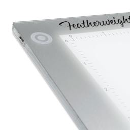 Artograph Featherweight LightPad - 12" x 17" (Close-up of power button in upper left corner)
